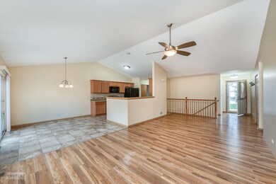 Living Room, Kitchen, Foyer, and Open Stairway to