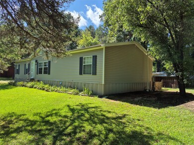 View of side of property featuring a lawn