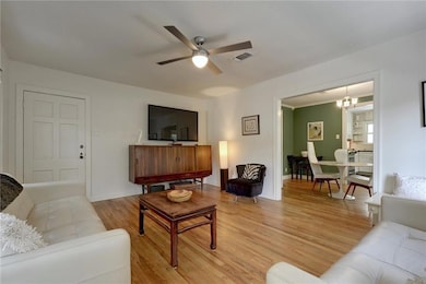 Living room with light wood-type flooring, a ceil