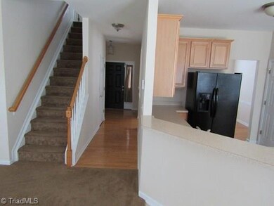 Breakfast room looking into downstairs hall and kitchen steps to upstairs.