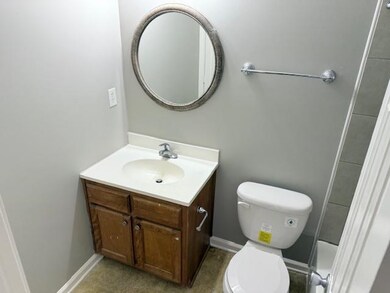 Bathroom with baseboards, vanity, and toilet