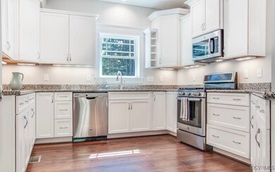 Kitchen featuring light stone countertops, dark ha