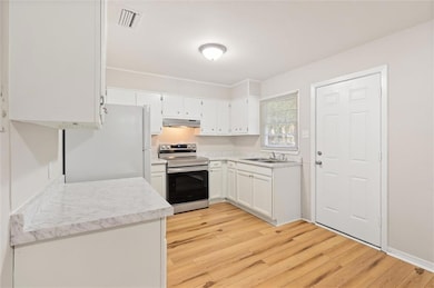 Kitchen with light hardwood / wood-style floors, s