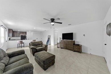 Tiled living room featuring ceiling fan