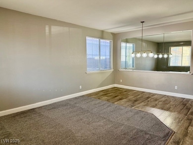 View from front door,  room with healthy amount of natural light and wood finished floors