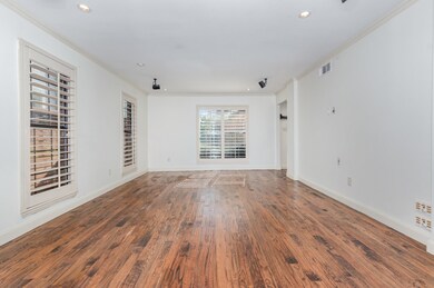 Spare room with wood finished floors, ornamental molding, and recessed lighting