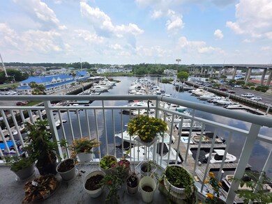 Balcony featuring view of marina and a water view