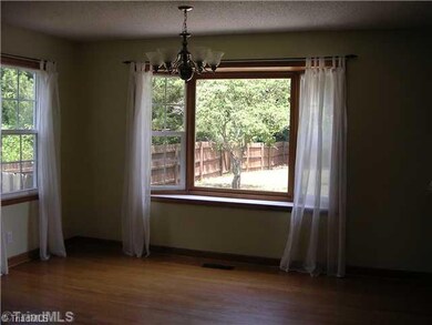 Dining Room. Dining Room Featuring Hardwoods and Bay Window