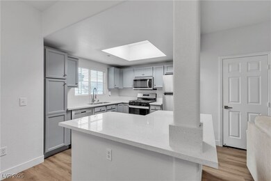 Kitchen featuring gray cabinetry, appliances with