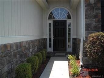 Front door with manicured landscape, side lights a