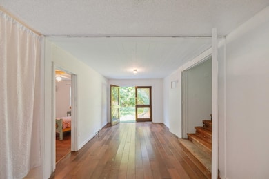 Hallway featuring hardwood / wood-style floors and stairs