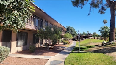 View of community with a lawn and a balcony