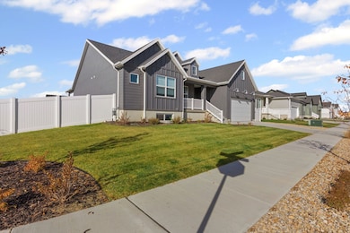 View of front of home with board and batten siding, a porch, concrete driveway, a garage, and a residential view