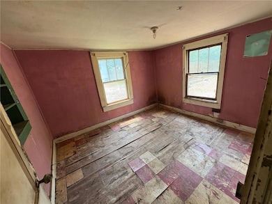 Spare room with plenty of natural light and baseboards