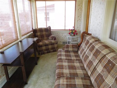Sun porch leads to driveway.
