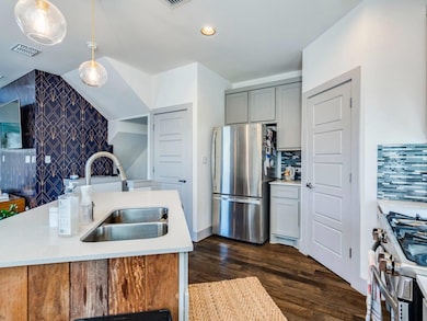 Kitchen with visible vents, a sink, light counter