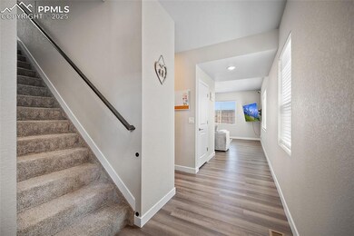 Stairs featuring baseboards, wood finished floors, and recessed lighting