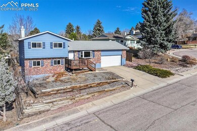 Split level home with a garage, brick siding, a ch