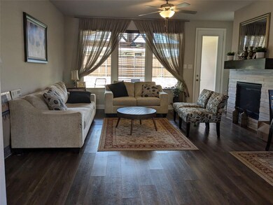 Living room featuring ceiling fan and dark hardwood / wood-style floors