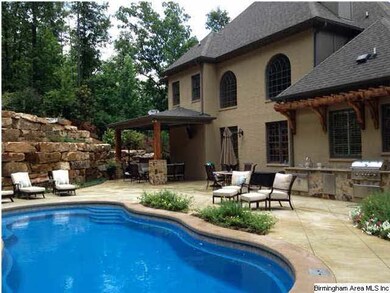 Back yard features a salt water pool with a gas he