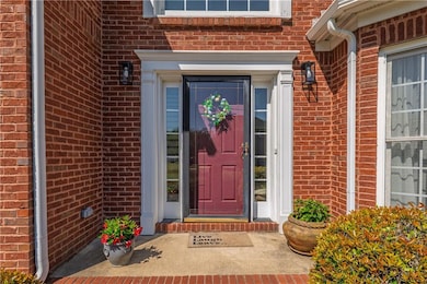 Doorway to property featuring brick siding