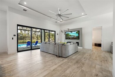 Living area with ceiling fan, a raised ceiling, re