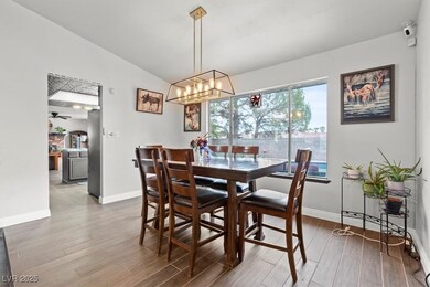 Dining area with lofted ceiling and wood finished floors