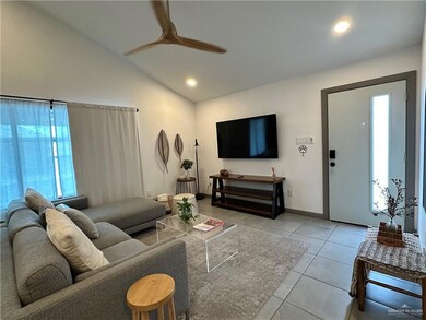 Living room featuring ceiling fan, light tile patterned floors, vaulted ceiling, and recessed lighting