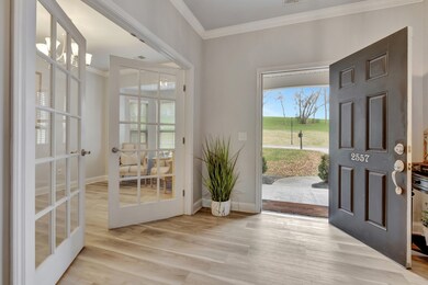Office or formal living area has French Doors, bay windows and laminate floors throughout the downstairs.