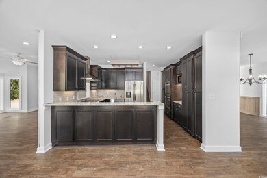 Kitchen with dark brown cabinetry, dark wood-type 