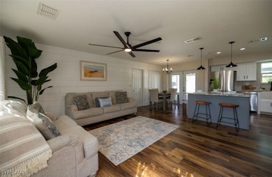 Living room featuring ceiling fan, french doors, a