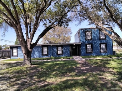 Traditional-style house with a front lawn and fence
