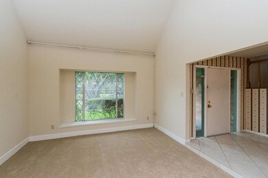 Sunken Living room has 2-story ceiling, fresh paint and new carpet.