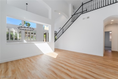 Entrance foyer with a chandelier, a towering ceili