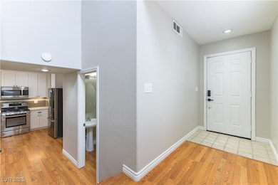 Entrance foyer with light wood finished floors and