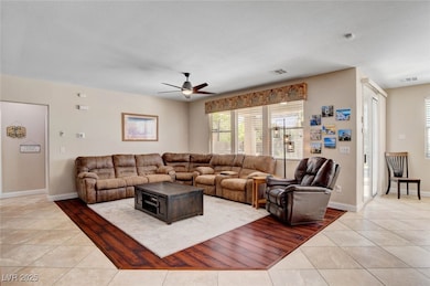 Large family room featuring a ceiling fan with lig
