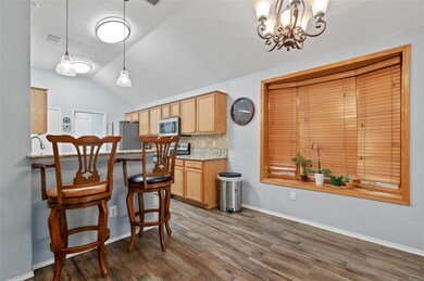 Kitchen with tasteful backsplash, appliances with 