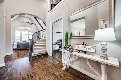 Foyer opens to a sweeping staircase.