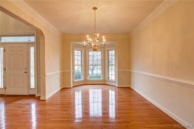 Dining Room - Hardwood Floors, Crown and Chair Moudling, Bay Window, Chandelier Lighting