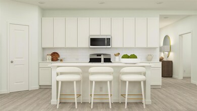 Kitchen featuring light wood-style flooring, white