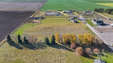 Aerial view of property and surrounding area featuring rural landscape and abundant farmland