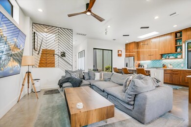 Living room featuring finished concrete flooring,
