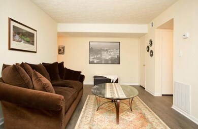 Living room with hardwood / wood-style floors and 