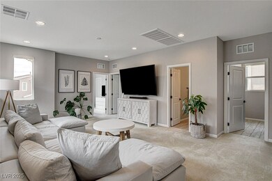 Living area with light carpet, recessed lighting,