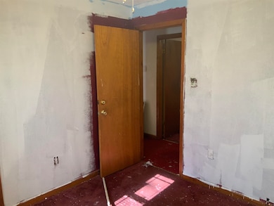 Empty room featuring baseboards