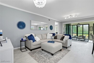 Living area featuring ornamental molding and a chandelier