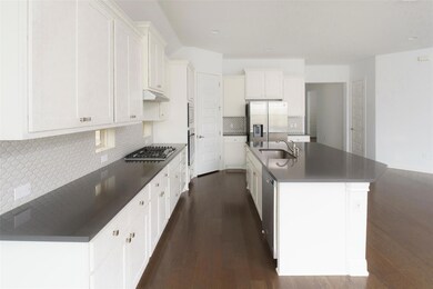 Kitchen with stainless steel appliances, dark woo