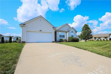 View of front of house with a front yard and a garage