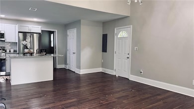 view of living room looking into kitchen from the front door