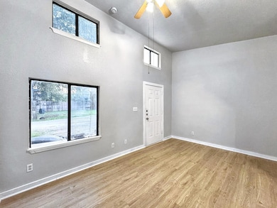 Foyer featuring baseboards, ceiling fan, wood fin